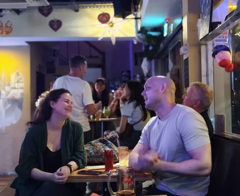 Guests smiling and talking around a table