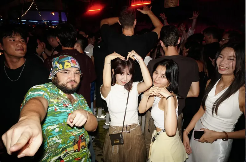 Guests posing together in a busy bar