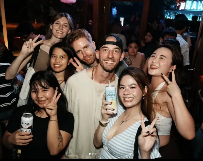 Guests smiling and posing together at a Taipei bar