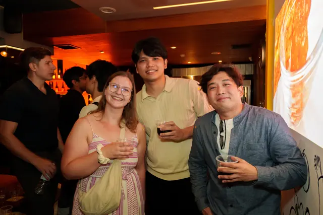 Guests smiling together over drinks