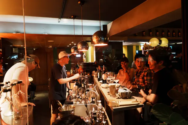 Guests sitting and chatting along the bar
