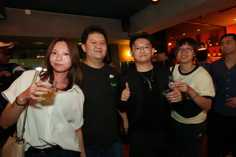 Four guests posing together inside the bar