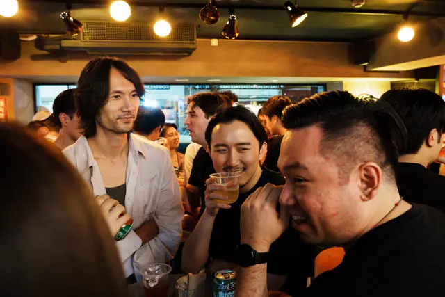 Guests sharing a conversation in a busy bar