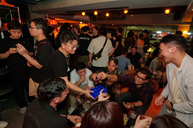 Guests gathered around a table, chatting and playing together