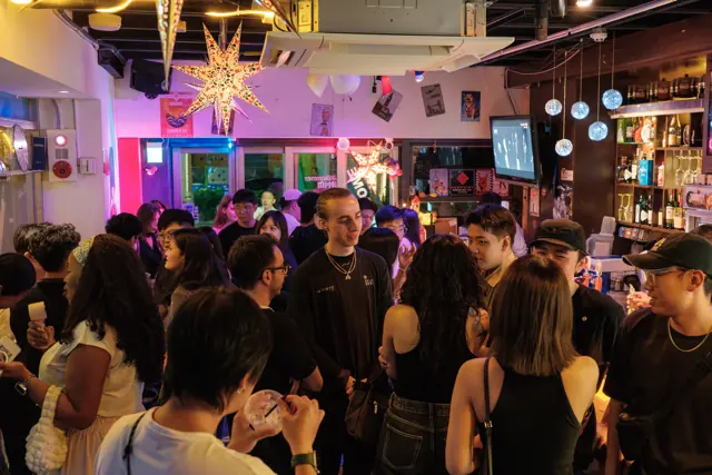 A room full of guests talking in small groups