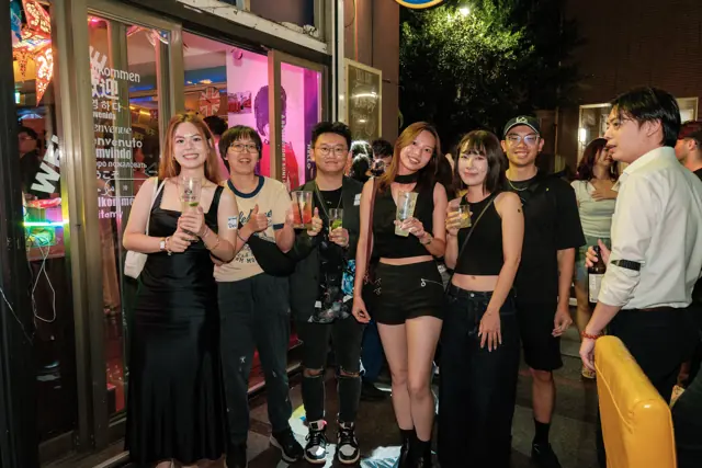 Guests gathered outside Tea Bar at night