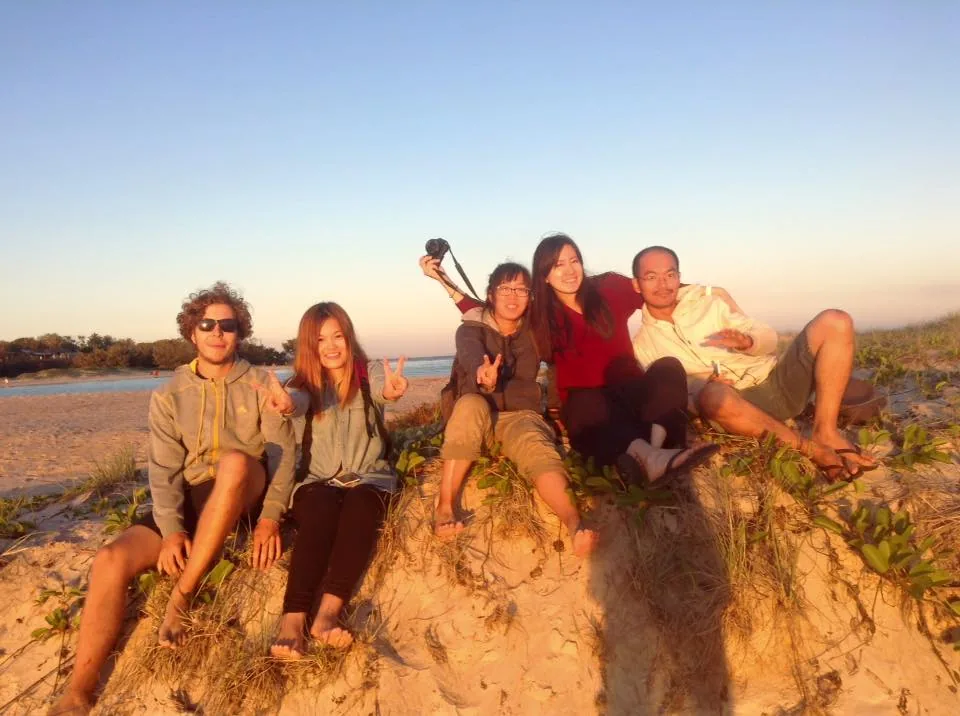 Yi and friends together by the sea